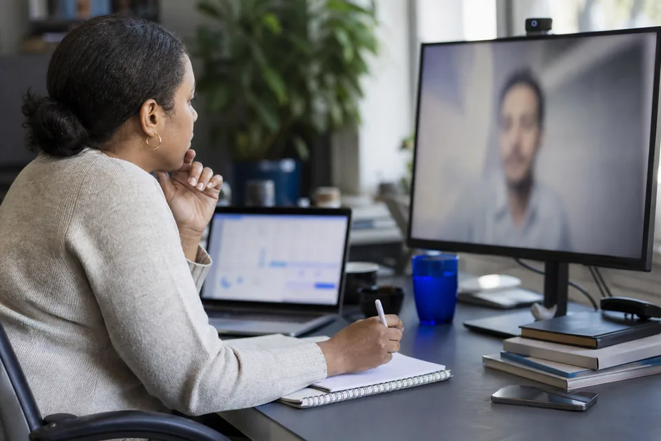 Head of talent reviewing remote applicants with a colleague on a video call